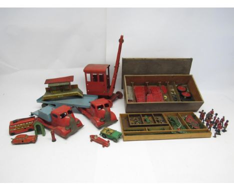 A mixed group of vintage playworn toys including pressed steel truck, articulated flatbed truck and crane, wooden chest of lo