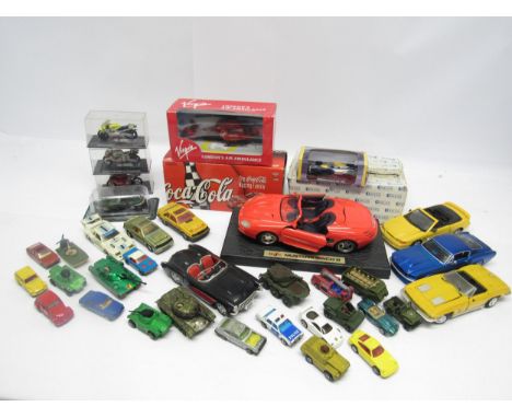 A collection of boxed and loose diecast vehicles including Action NASCAR stock car, perspex cased motorcycles, Atlas Editions