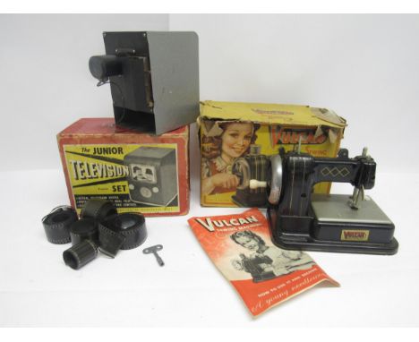 A Junior Television Set clockwork projector in original box depicting Laurel &amp; Hardy, and a Vulcan tinplate sewing machin
