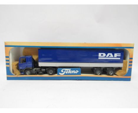 A boxed Tekno 1:50 scale diecast heavy haulage model DAF FT85 cab and trailer (box worn and lacking cellophane window)