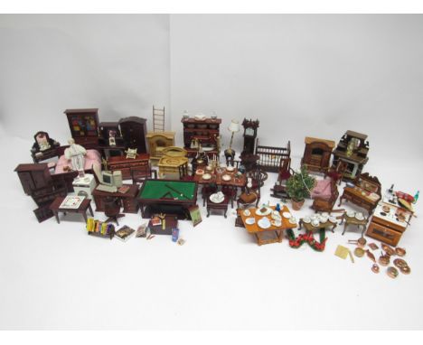 A collection of wooden dolls house furniture and accessories including dresser, wardrobe, beds, cots, fireplaces, dining tabl