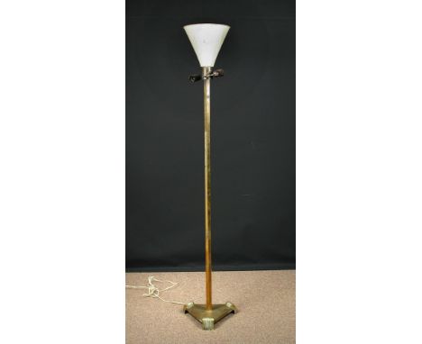 An Art Deco brass standard lamp/uplighter, the painted metal shade raised on a hexagonal column and triangular base raised on