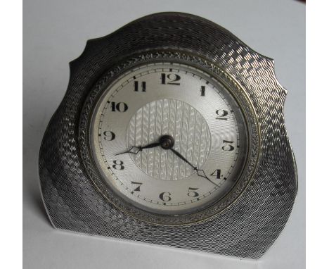 An Art Deco engine turned eight-day silver framed easel back bedside clock with Arabic numerals by John Henry Wynn, Birmingha