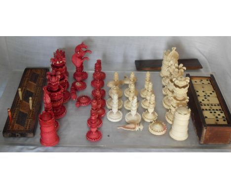 A 19th century Anglo / Chinese red stained and white carved ivory chess set, some pieces damaged, set of dominoes in original