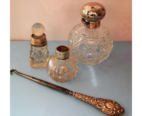 A Victorian silver topped cut-glass perfume bottle, Birmingham 1901, a smaller scent bottle with silver collar and one other 