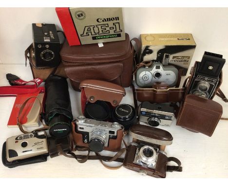 A collection of cameras, vintage, with lenses, video camera, Canon lens, accessories etc with tripod stands