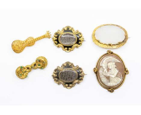 A collection of Victorian brooches, comprising two gilt metal mourning brooches with hair compartment and enamel decoration, 