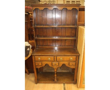 Small oak reproduction kitchen dresser with gallery base, two drawers over three small and two shelf plate rack