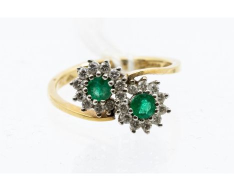 An emerald and diamond double cluster, 18ct gold ring, size N, total gross weight approx 4gms Condition report: good- stones 