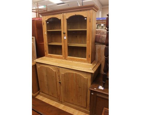 A late 19th Century pine glazed dresser and cabinet, the upper section fitted with two glazed doors enclosing two plate racks