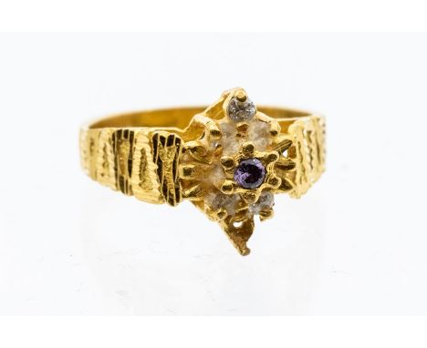 An unmarked  yellow metal ring set with paste stones, assessed as 18ct gold, size O1/2, total gross approx 6.1gmsCondition re