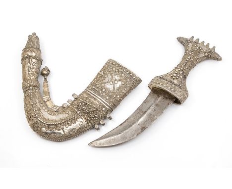 A 19th Century Arabian Janbiya shortsword and white metal scabbard, Yemen, the hilt and sheath (Asib) with profuse decoration