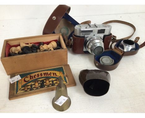 Vintage 1960's camera, box of chess pieces, two cattle bells
