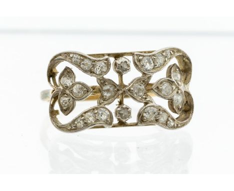 An early 20th Century diamond set 18ct gold ring, comprising a lozenge shaped open work foliate top grain set with small diam