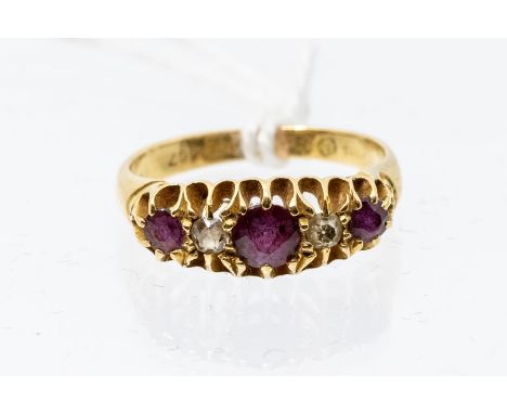 An ruby and diamond 18ct gold ring, comprising three round graduated cut rubies with two diamond set accents, size K1/32, tot