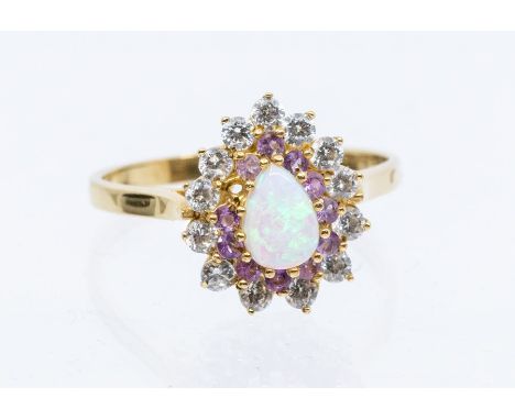 An opal and paste set 9ct gold cluster ring, set to the centre with a pear cut opal, with a double surround set with lilac an