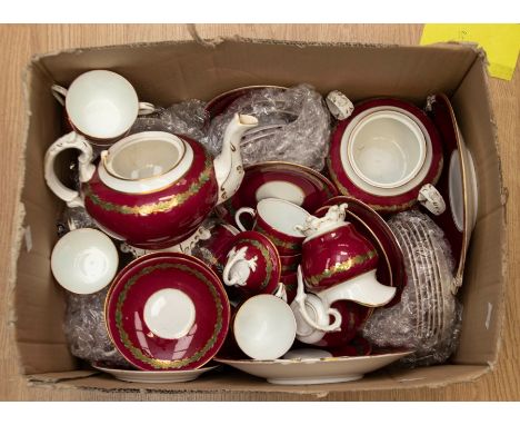 A late 19th Century Victorian burgundy ground tea service with teapots, cream and sugar, sandwich and biscuit plates etc Q