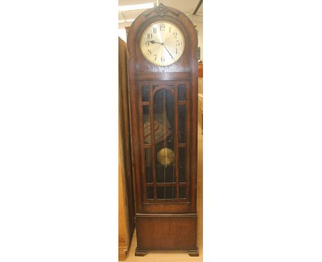 An early 20th Century oak longcase clock, with Westminster, Whittington and St. Michael chimes, glazed door, with two brass c