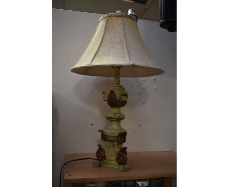 A French Empire style table lamp, in craquelure effect, having a cream shade, with a turned column, gilded acanthus decoratio