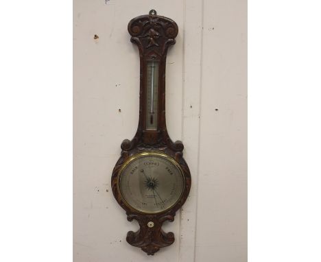 A late 19th Century oak barometer and thermometer, by J Jerome Large, Birmingham