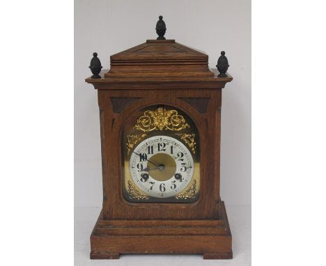 An oak cased early 20th Century mantle clock, with Georgian style face, Arabic numerals, eight day