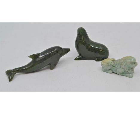 Two dark green jade sea mammals, a Chinese jade foe dog