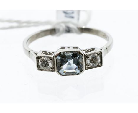 An aquamarine and diamond platinum dress ring, rub over set to the centre with a square mixed cut cut aquamarine, stone weigh