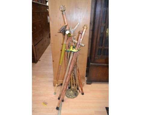 Cast brass stick stand with a collection of walking sticks