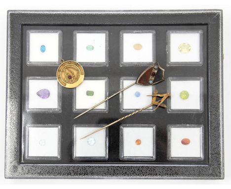 A boxed collection of twelve assorted gemstones to include various semi precious stones in various cuts including amethyst, t