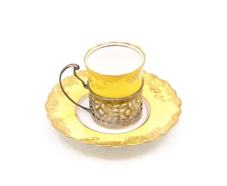 An Aynsley china coffee can and saucer pattern no: 04460 yellow ground with gilt decoration together with silver reticulated 