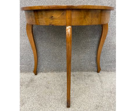 A 19th century continental walnut demi lune console table in the Beidermeier style. H.77 W.85 D.45cm.