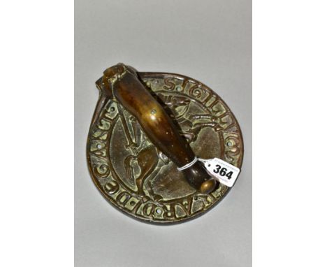 A 19TH CENTURY HEAVY BRONZE DOOR KNOCKER OF LEG FORM, mounted on a circular back plate of Knights Templar interest, cast with