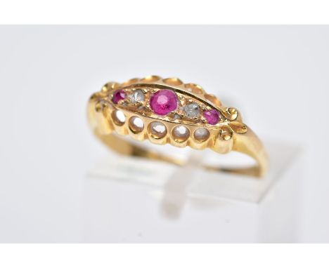 AN EARLY 20TH CENTURY 18CT GOLD BOAT RING, designed with three graduated, circular cut rubies interspaced with two rose cut d