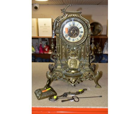 A LATE VICTORIAN BRASS CASED MANTEL CLOCK, the caddy top and one scrolled side arm loose, enamelled dial with Roman numerals 