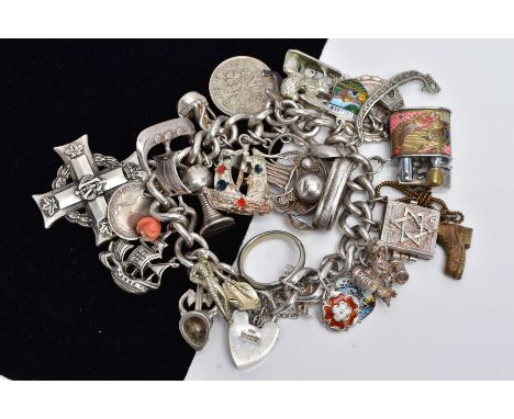 A HEAVY SILVER CHARM BRACELET, the stamped curb link bracelet suspending twenty-seven white metal charms, in forms such as a 