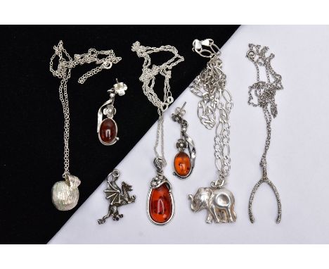FOUR WHITE METAL PENDANT NECKLACES, A PAIR OF AMBER EARRINGS AND A CHARM, to include an amber cabochon within a floral surrou