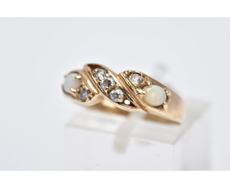 A 9CT GOLD OPAL RING, of a crossover design, set with five circular cut colourless cubic zirconia stones flanked with oval cu