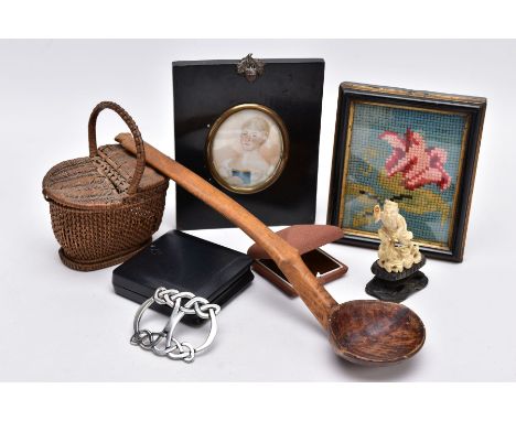 A BOX OF ASSORTED ITEMS, to include a 'St Justin' pewter belt buckle of a Celtic design, a black wooden miniature portrait of