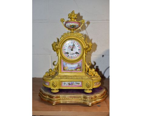 A MID 19TH CENTURY ORMOLU AND PORCELAIN MOUNTED MANTEL CLOCK, the case surmounted with a twin handled urn, the dial painted w