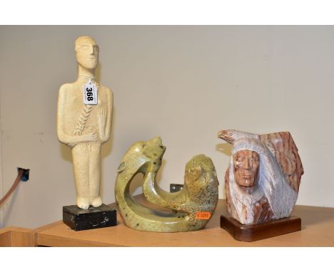 A 20TH CENTURY RAYMOND PETTIGREW CARVED STONE BUST OF A NATIVE AMERICAN INDIAN AND AN EAGLE, mounted on a wooden plinth, sign