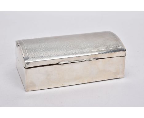 A SILVER LINED CIGARETTE BOX, of a chest form, engine turn design with a vacant cartouche, opens to reveal two compartments (