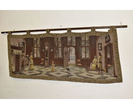 A 20TH CENTURY MACHINE WOVEN TAPESTRY WALL HANGING AND POLE, depicting a Dutch interior scene with figures and a dog, approxi