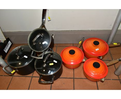 TWO SETS OF THREE GRADUATED LE CREUSET SAUCEPANS AND LIDS, one set in orange enamel with pouring lips, in sizes 16cm, 18cm an