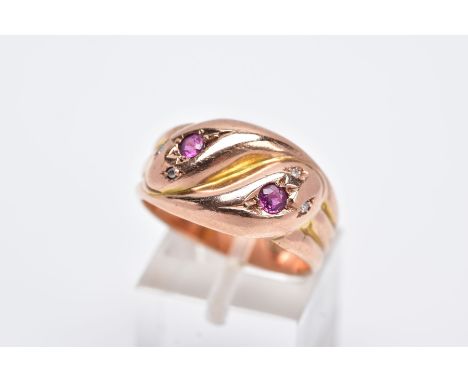 AN EARLY TWENTIETH CENTURY 9CT ROSE GOLD DOUBLE SNAKE HEAD RING, set with diamonds, a ruby and an amethyst, ring size R, hall