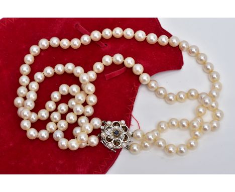 A CULTURED PEARL NECKLET, two strands of cultured pearls, individually knotted on a white cord, each pearl approximately 7.2m