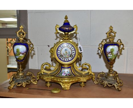 A MID 19TH CENTURY ORMOLU AND PORCELAIN MANTEL CLOCK, the case surmounted by an urn shaped finial and ribbon, the circular di
