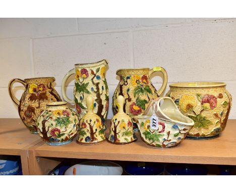 EIGHT PIECES OF H. J. WOOD RELIEF MOULDED 'INDIAN TREE' POTTERY, comprising three jugs, two bells, a planter, a flower basket