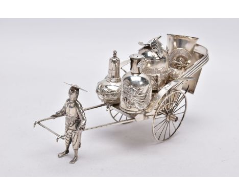 AN EARLY 20TH CENTURY CHINESE SILVER CONDIMENT SET, in the form of a street vendor pulling a cart, with a Dragon detailed sal