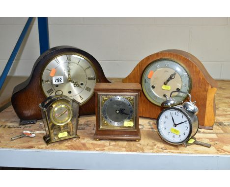 A GROUP OF FIVE CLOCKS, comprising two Smiths domed top oak cased mantel clocks, both with pendulums and keys, one over wound