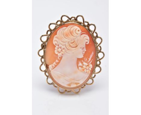 A 9CT GOLD CAMEO BROOCH, of an oval form, depicting a lady in profile, within a millegrain setting with a rope twist and open